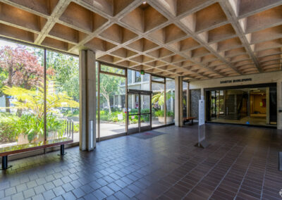 Entryway of 7901 Oakport. Tiled floors, decorative ceilings, and benches look out floor-to-ceiling windows.
