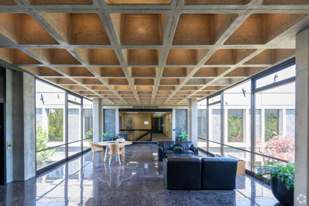 Entryway Lobby of 7901 Oakport. Marbled floors, leather couches and benches look out floor-to-ceiling windows.