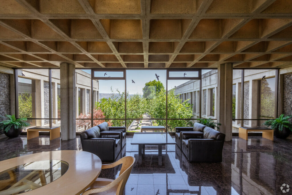 Entryway Lobby of 7901 Oakport. Marbled floors, leather couches and benches look out floor-to-ceiling windows.