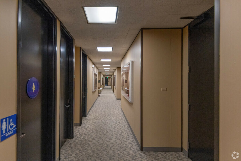 Common area hallway, with private bathrooms and suite entrances.