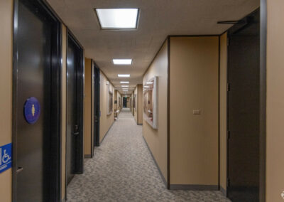 Common area hallway, with private bathrooms and suite entrances.