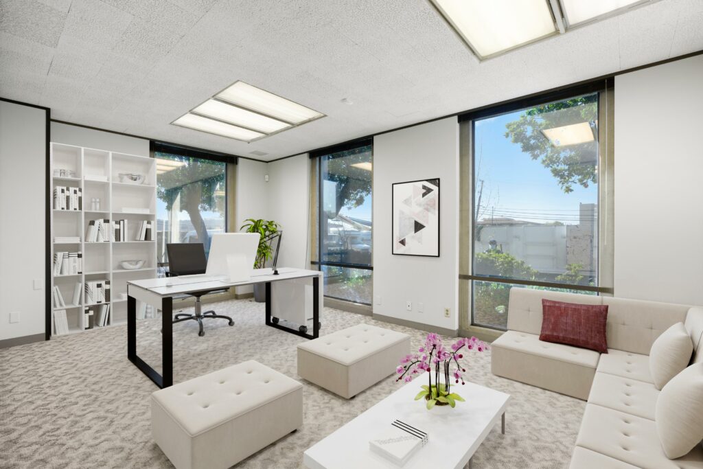 Virtually staged executive office in suite. 3 Floor-to-ceiling windows line the right wall and corner.