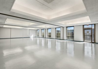 A virtually staged photo of the main open space of Suite #1000. Six floor-to-ceiling windows line the right wall.