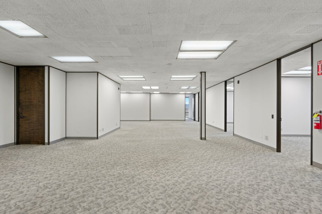 The main open space of Suite. Private offices line the walls.